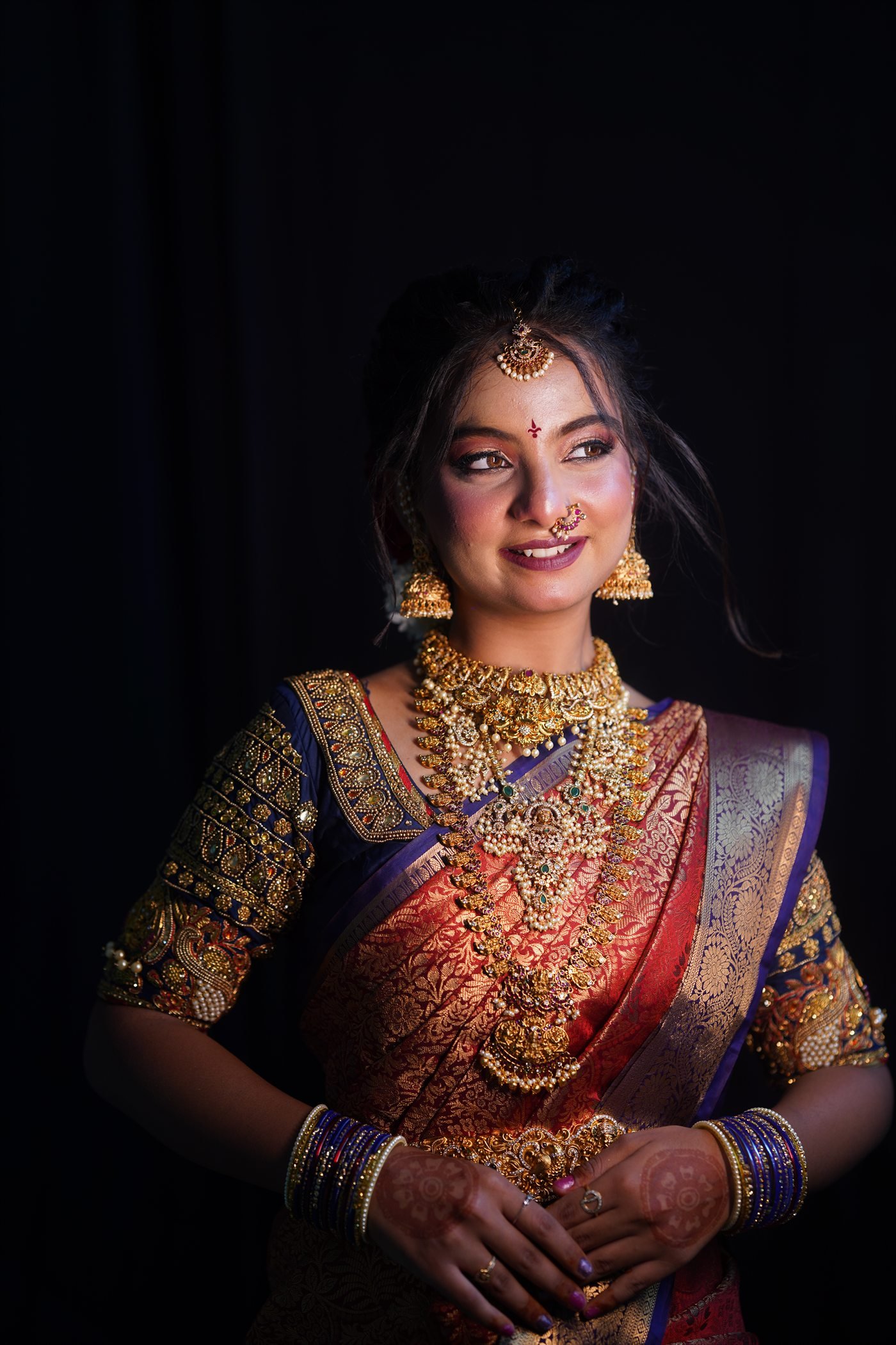 Traditional bridal makeup look with a dark studio background